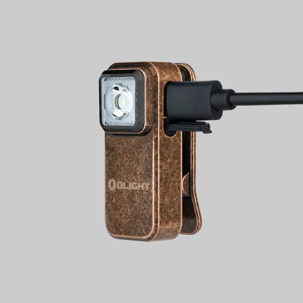 A Olight Oclip Clip Light by Urban Go Prep