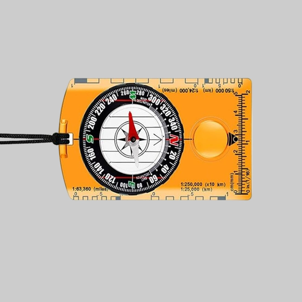 Orange compass with measurement scale on a gray background