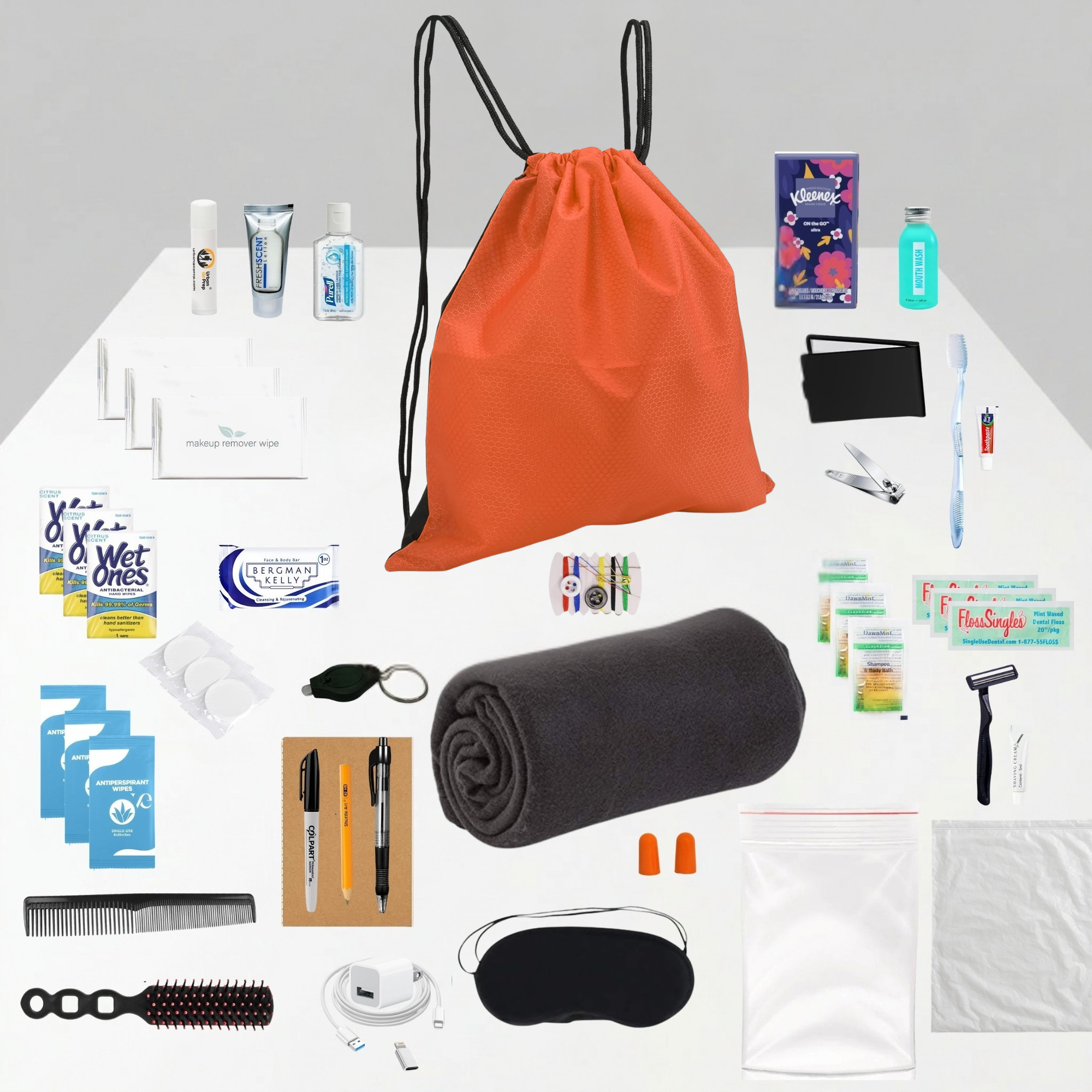 Collection of travel items including an orange drawstring bag, toiletries, and personal care products on a white background.