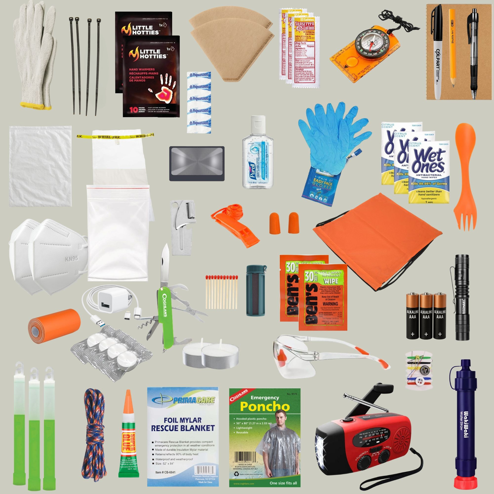 Collection of emergency supplies including blankets, flashlights, and first aid kits on a gray background.