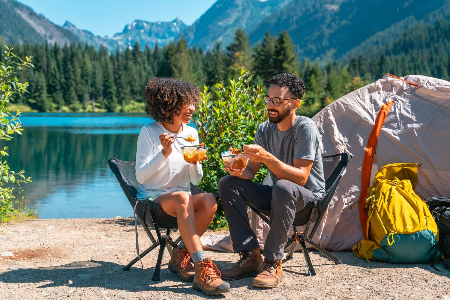 A man and woman camping by lake
