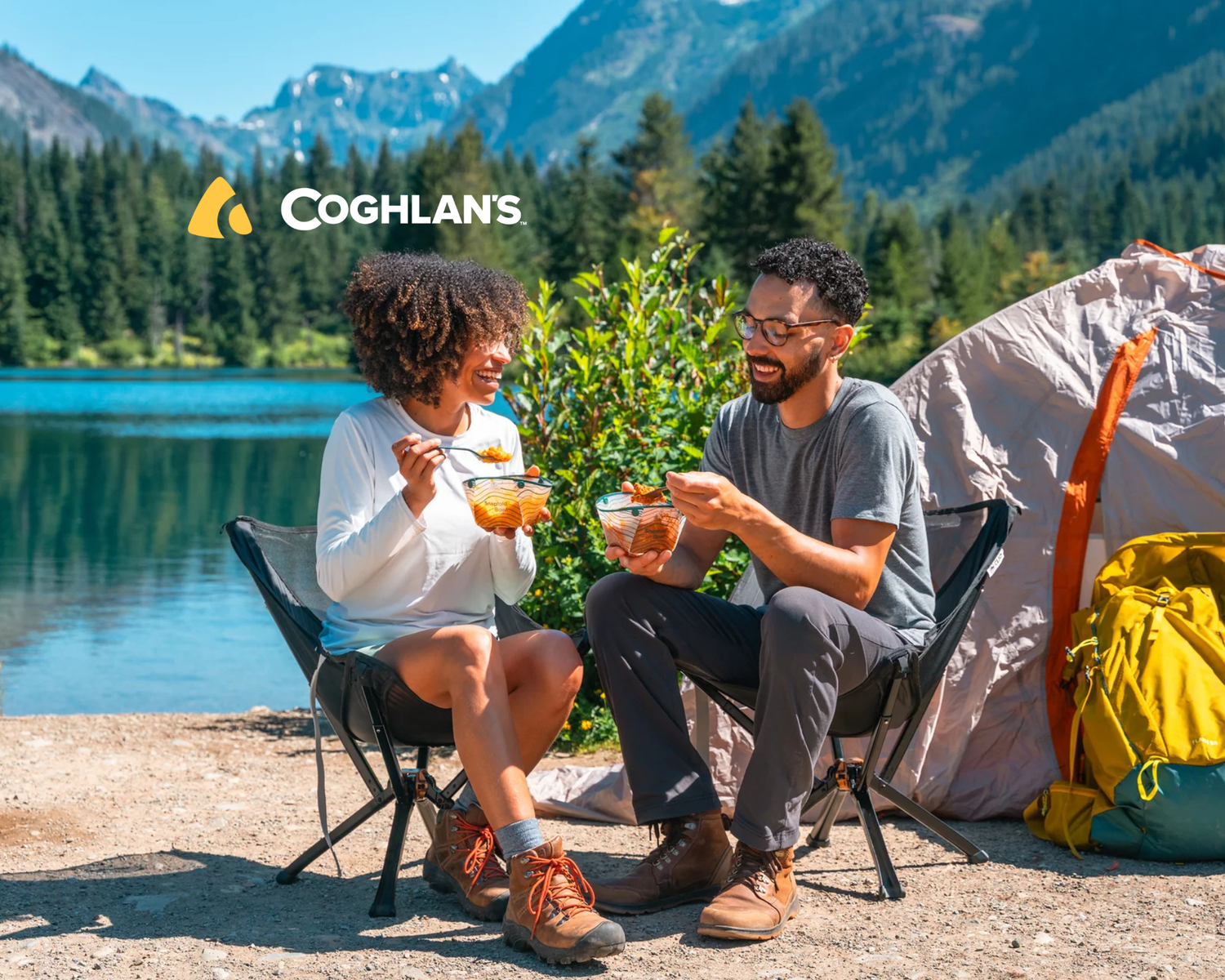 A man and woman camping by lake