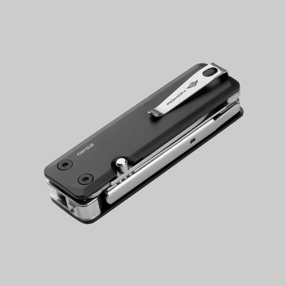 Black and silver multi-tool on a gray background