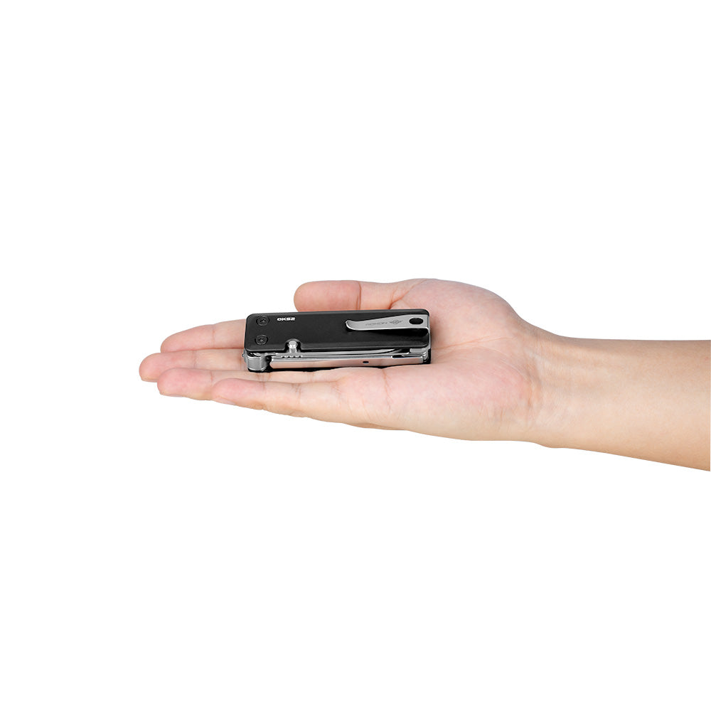 Olight OKS2 Multi-Tool Knife emergency survival tool held on hand on white background.
