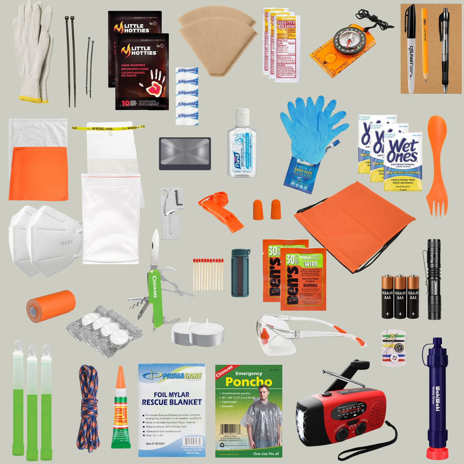 Collection of emergency supplies including gloves, bandages, and a radio on a grey background
