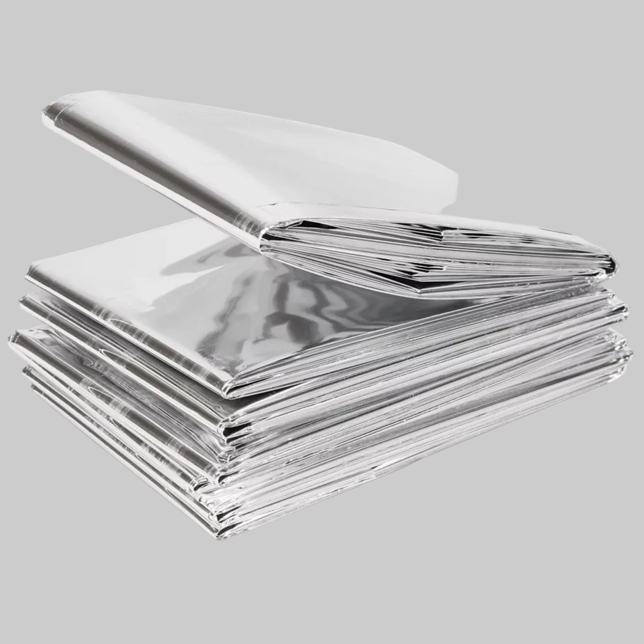 Folded Mylar Emergency Blanket on a gray background