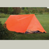 Orange tube tent on grass with trees in the background